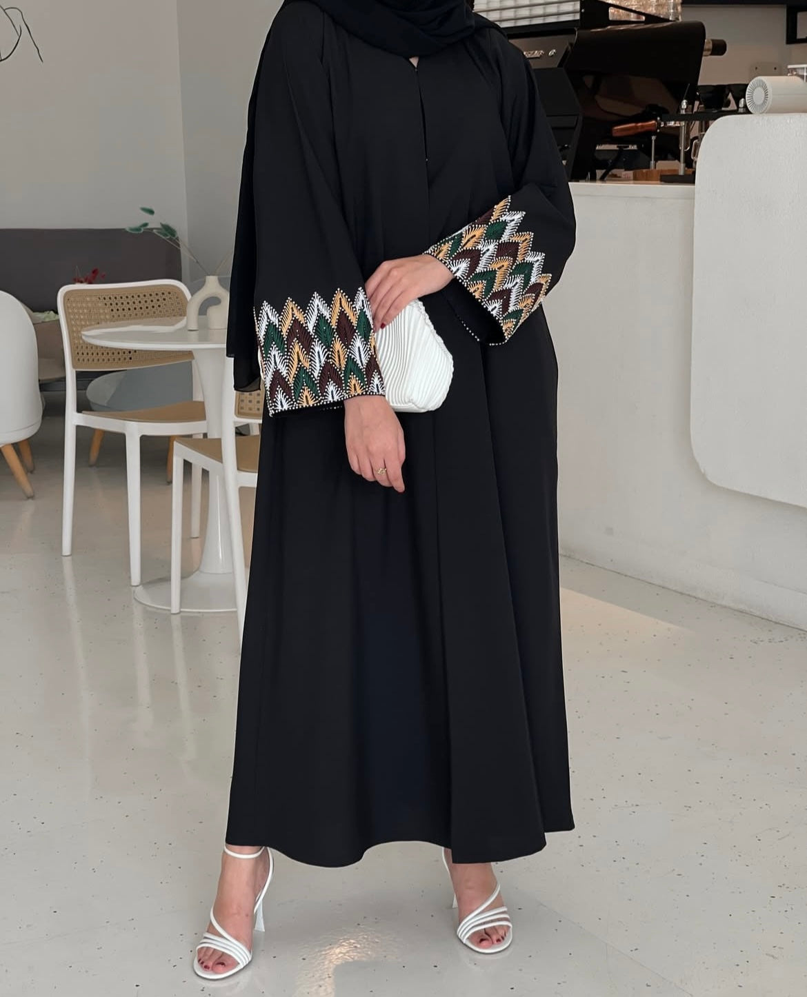 Black abaya has unique details on the sleeves