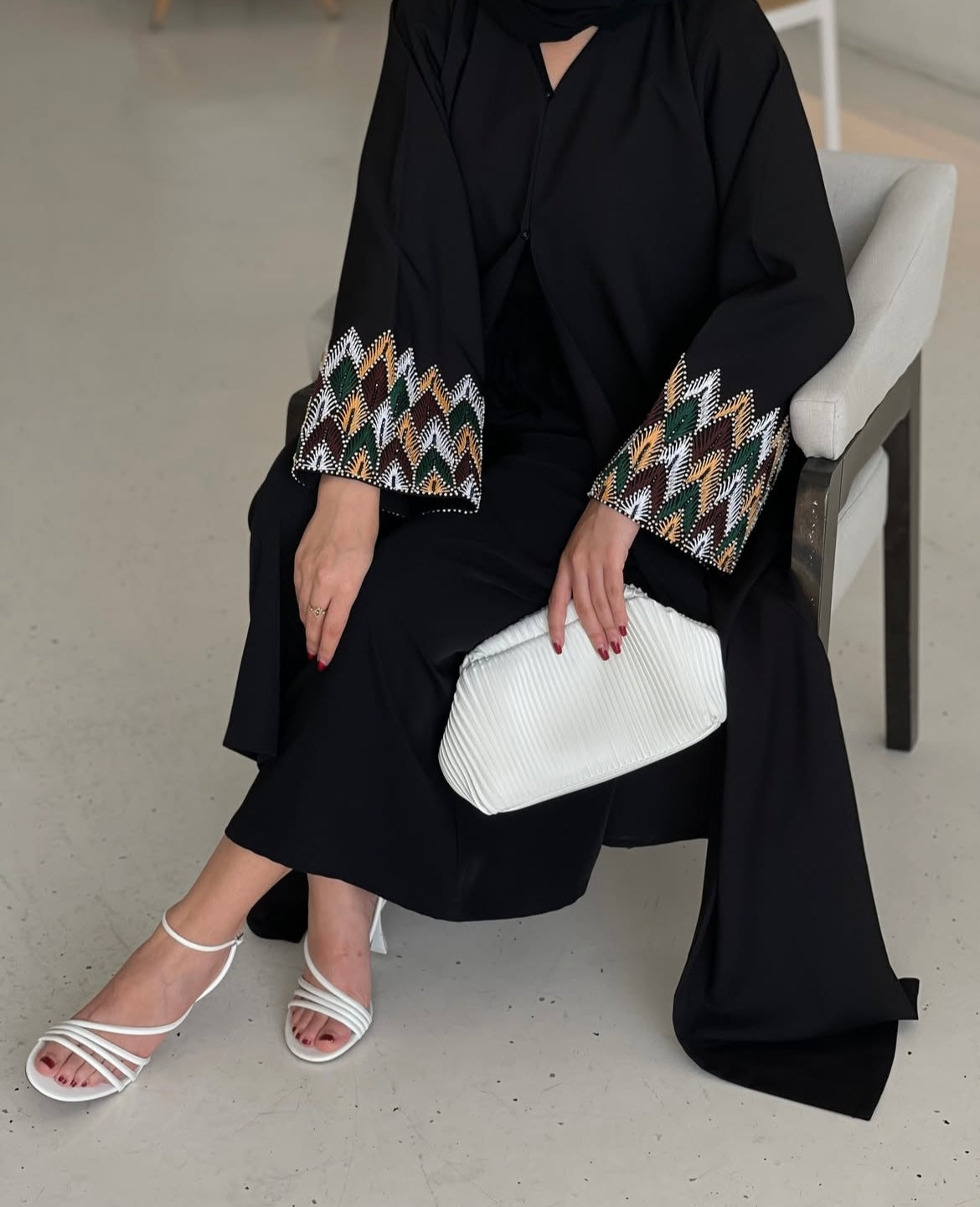Black abaya has unique details on the sleeves