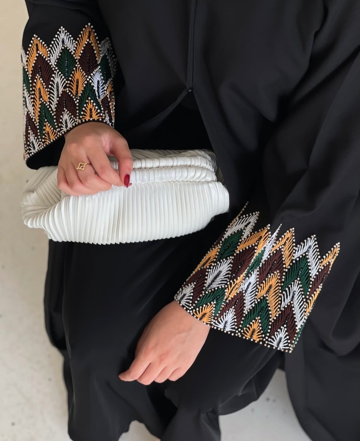 Black abaya has unique details on the sleeves