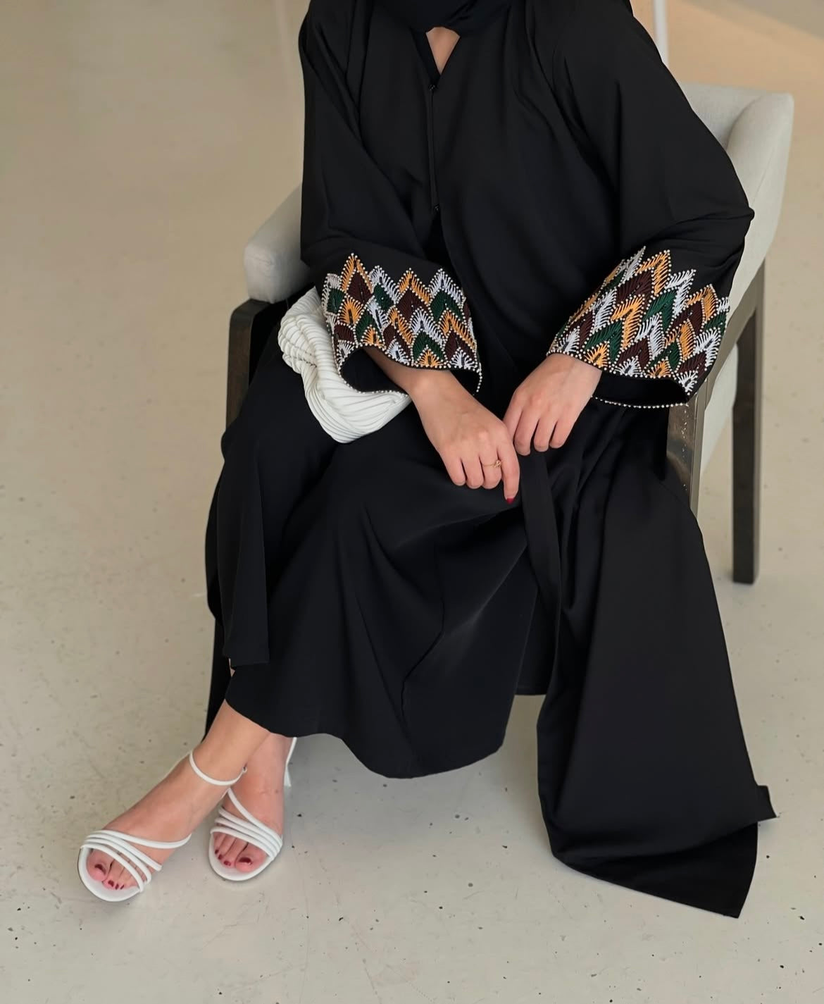 Black abaya has unique details on the sleeves