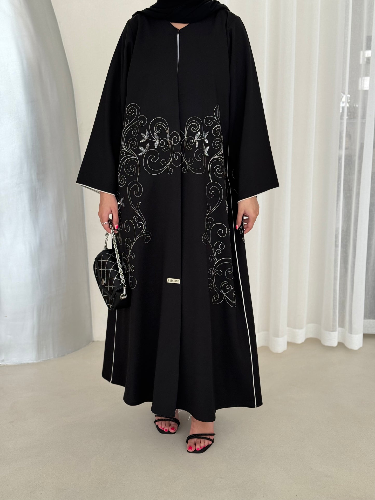An elegant abaya adorned with intricate embroidery