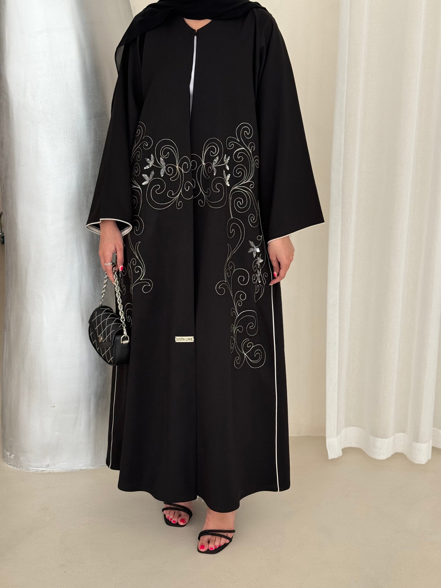 An elegant abaya adorned with intricate embroidery
