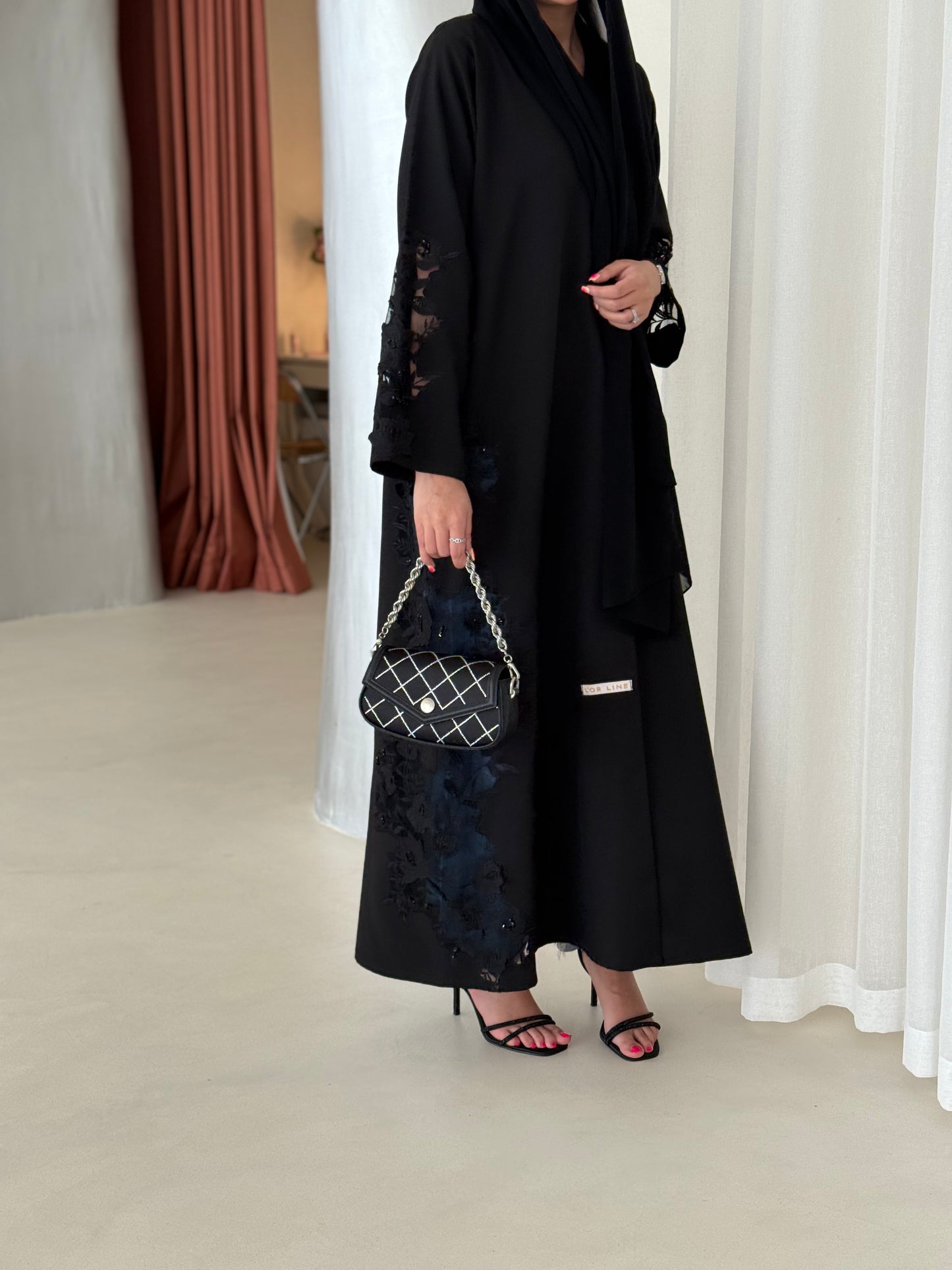 A full black abaya with a Klosh cut