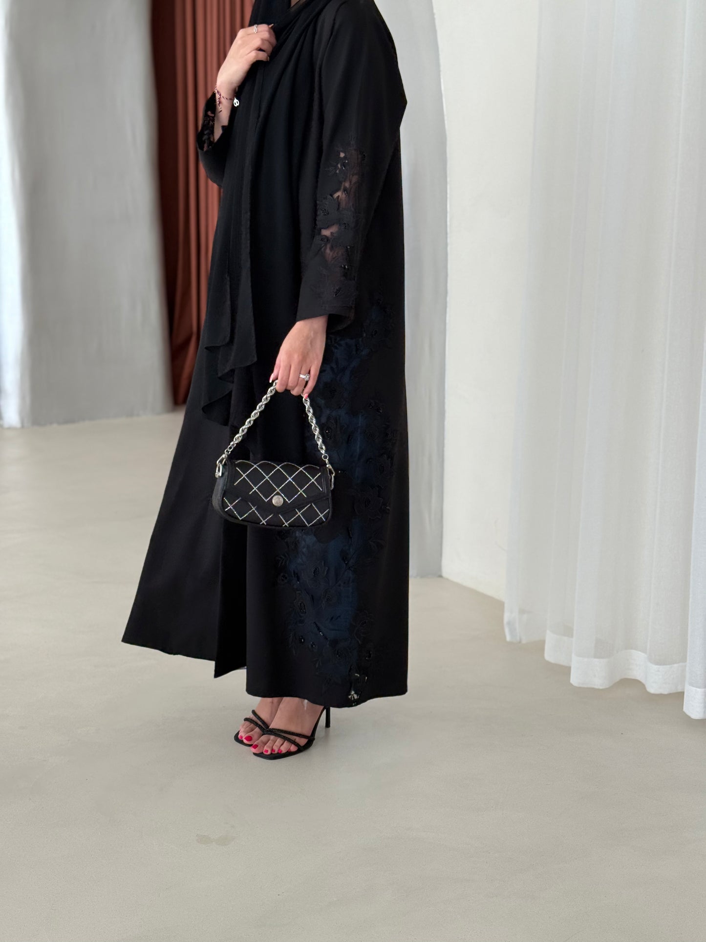 A full black abaya with a Klosh cut