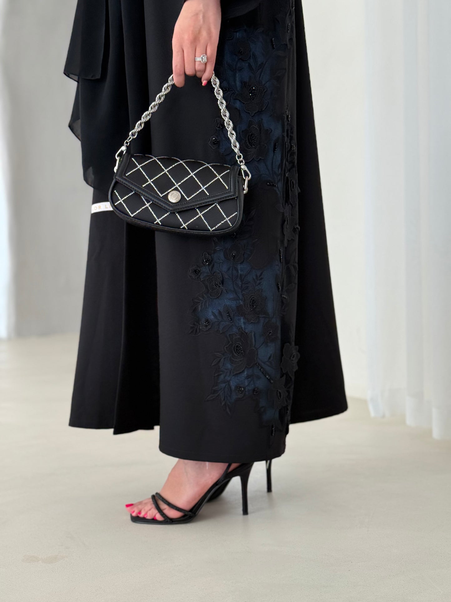 A full black abaya with a Klosh cut