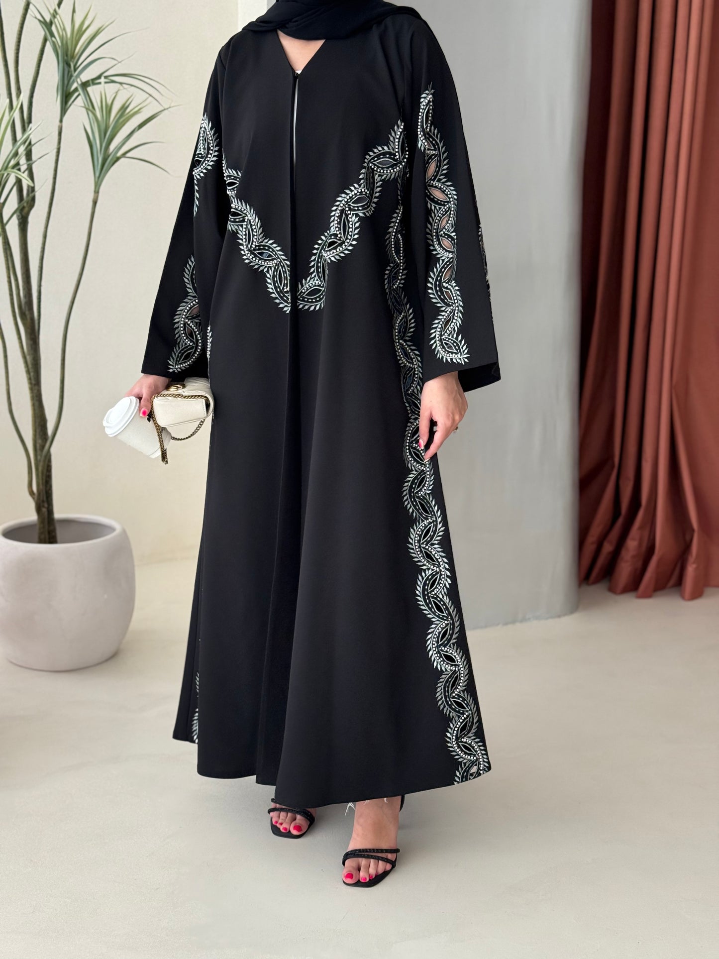 A black and soft green abaya
