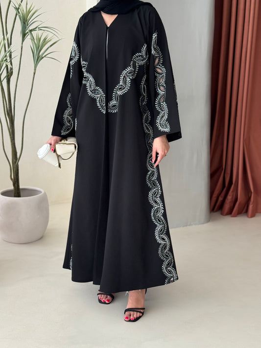 A black and soft green abaya