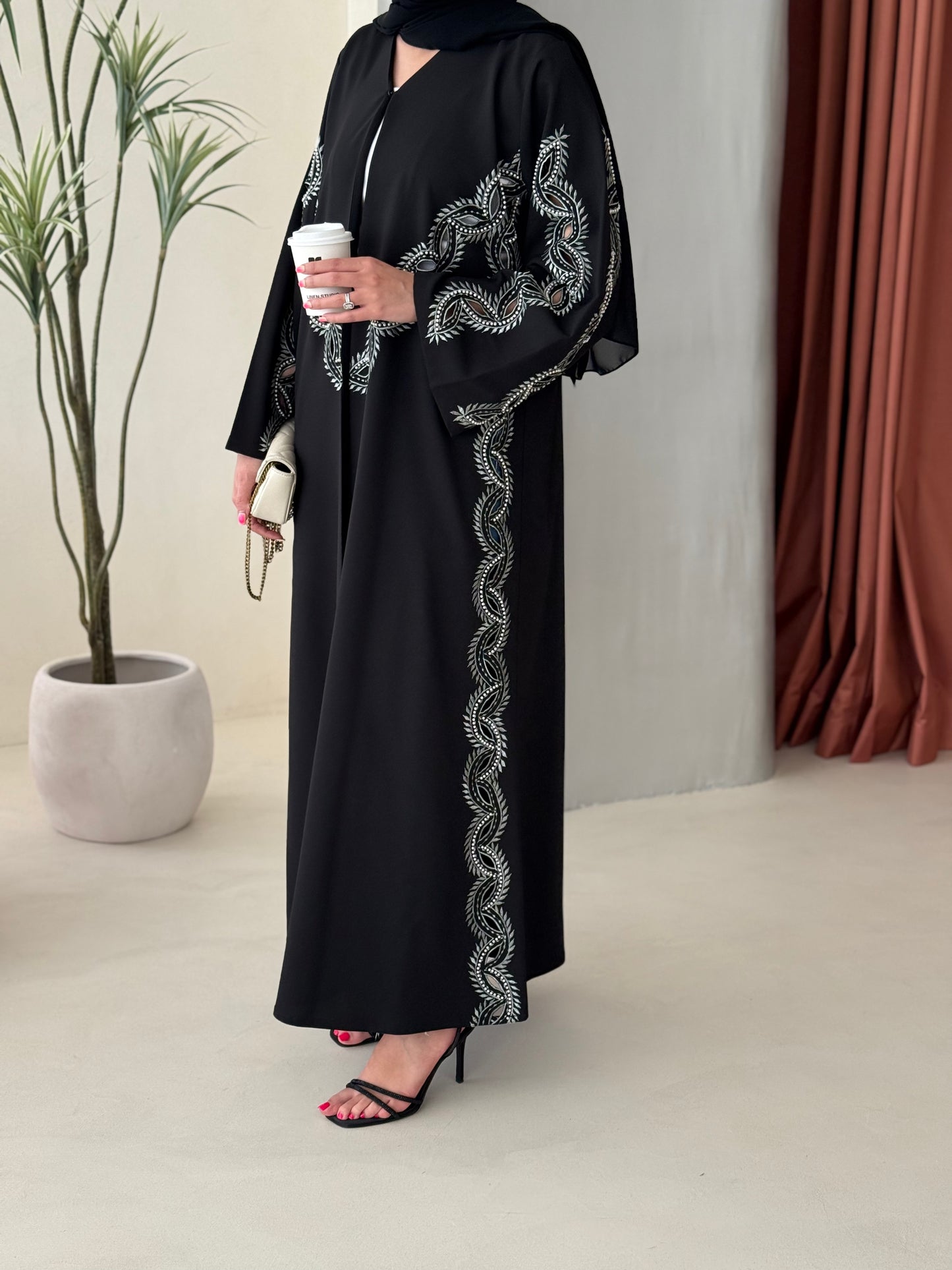 A black and soft green abaya