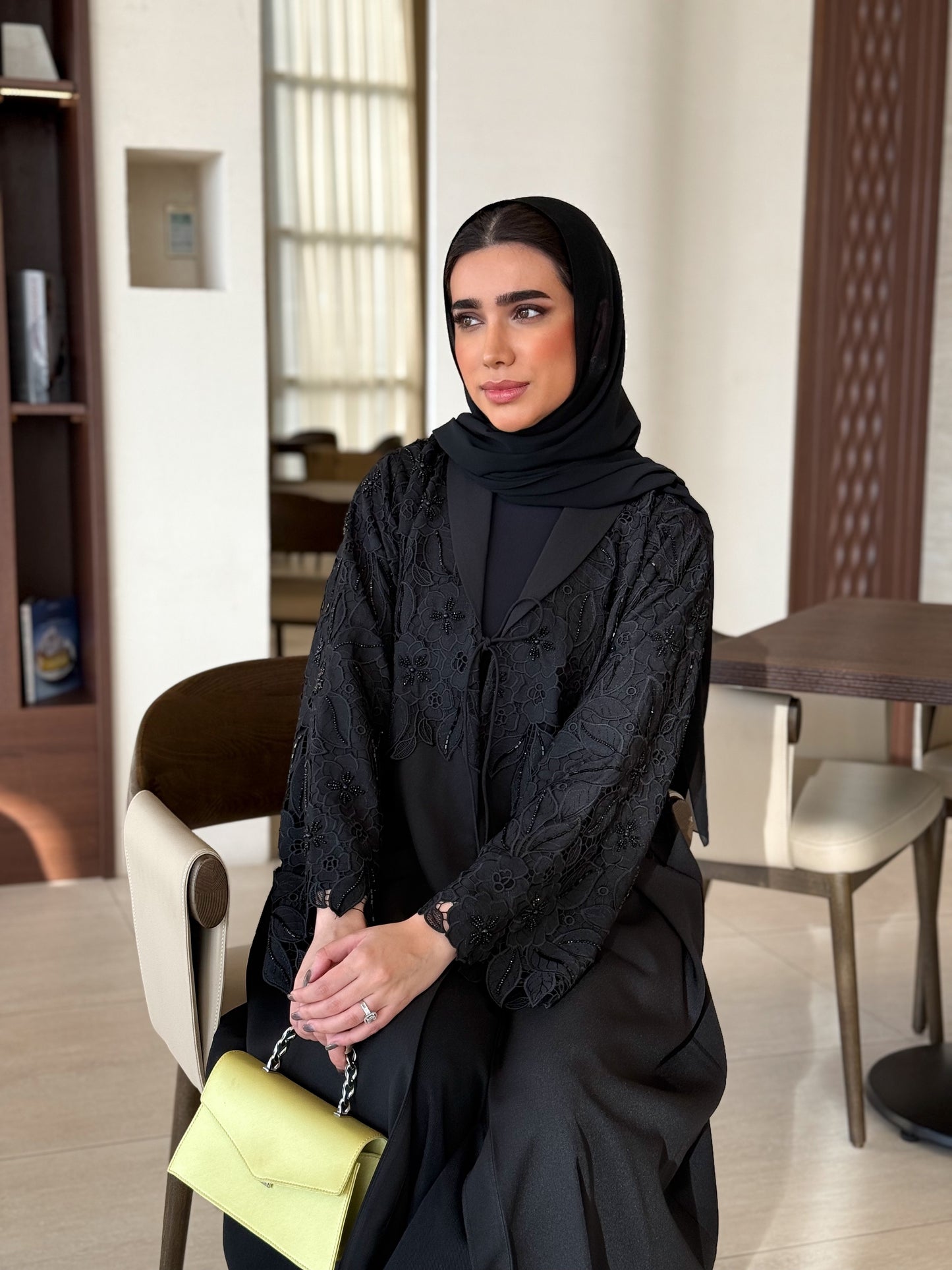 A black abaya with collar and unique embellishments
