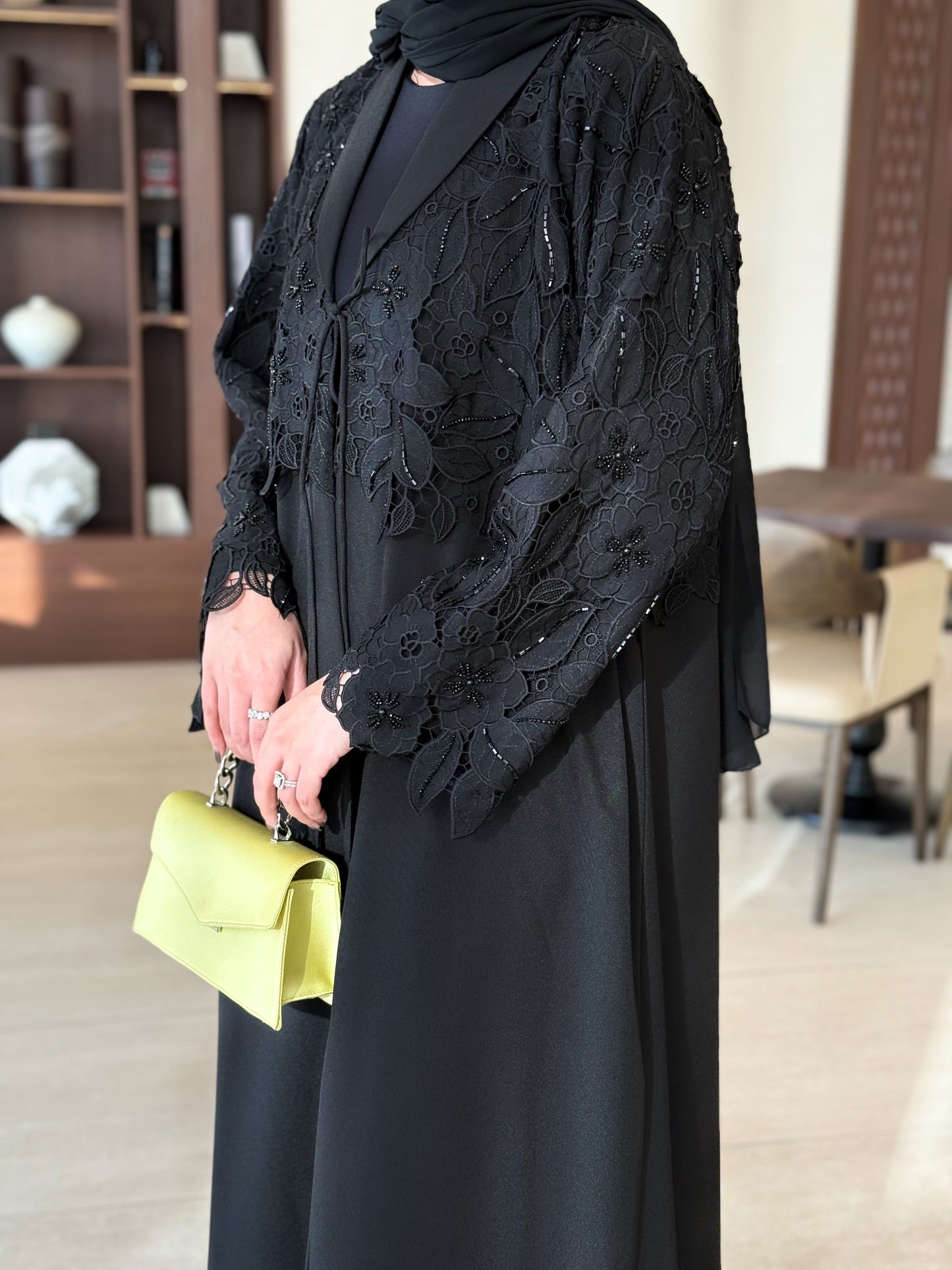 A black abaya with collar and unique embellishments