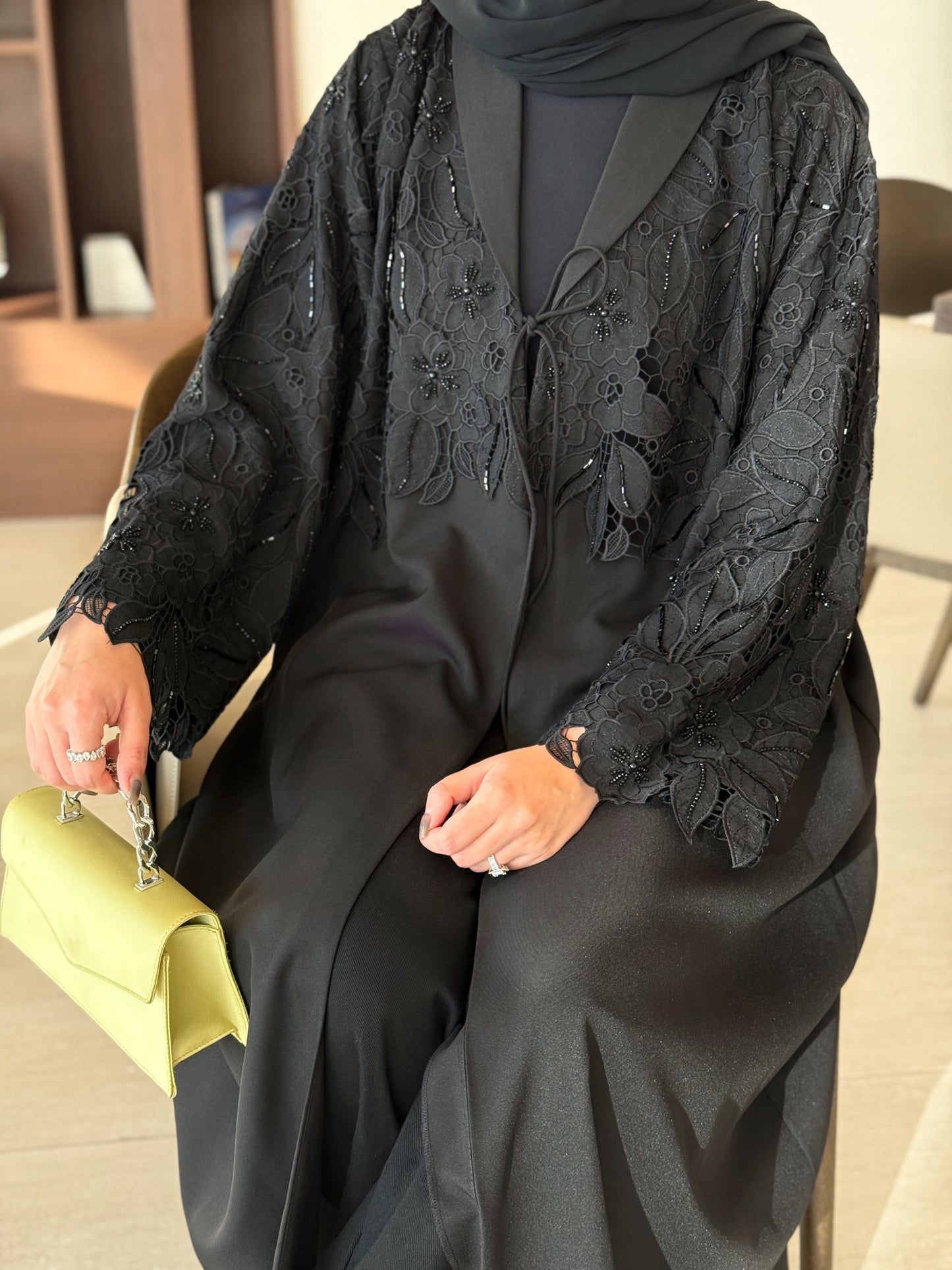 A black abaya with collar and unique embellishments