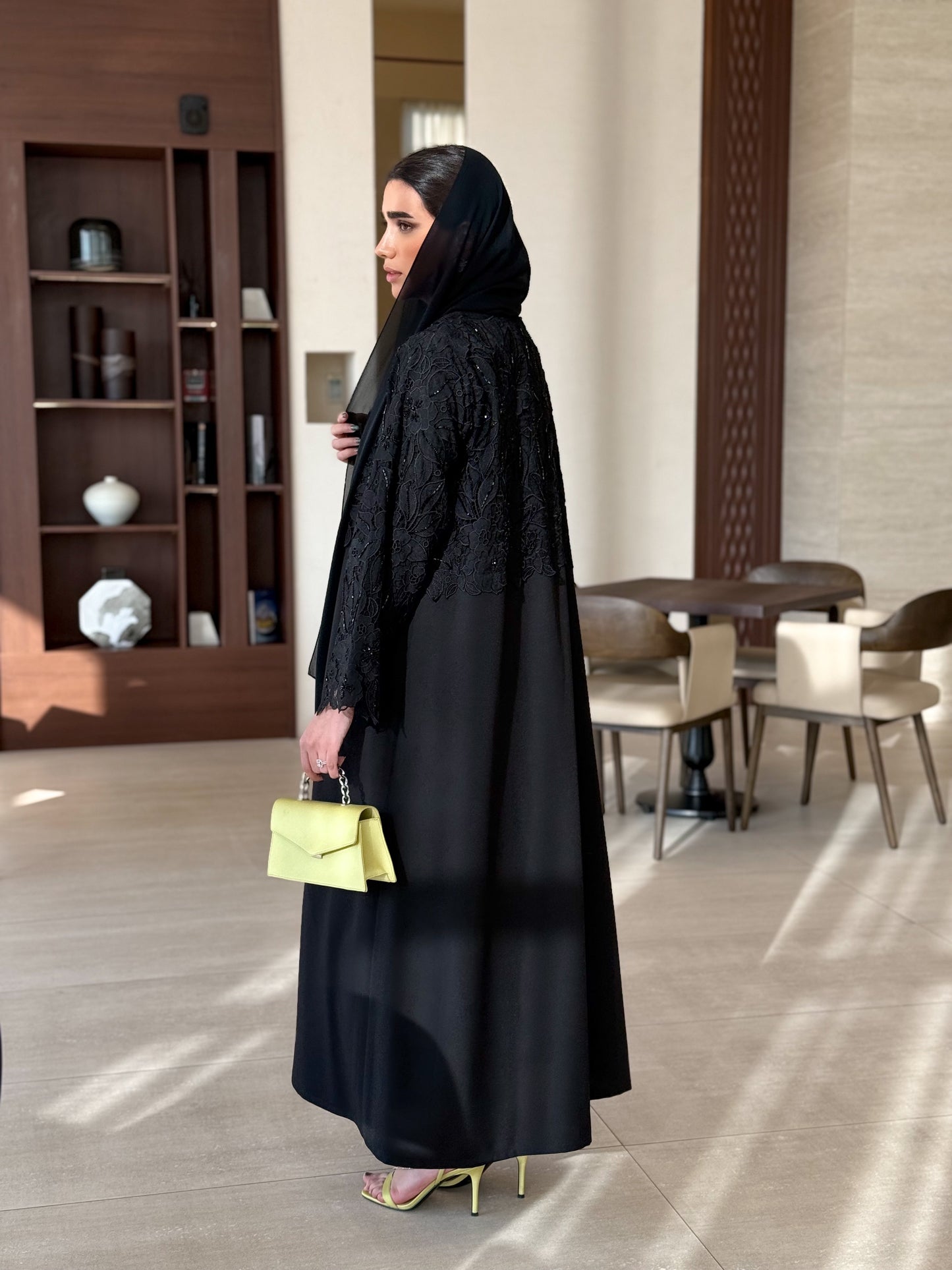 A black abaya with collar and unique embellishments