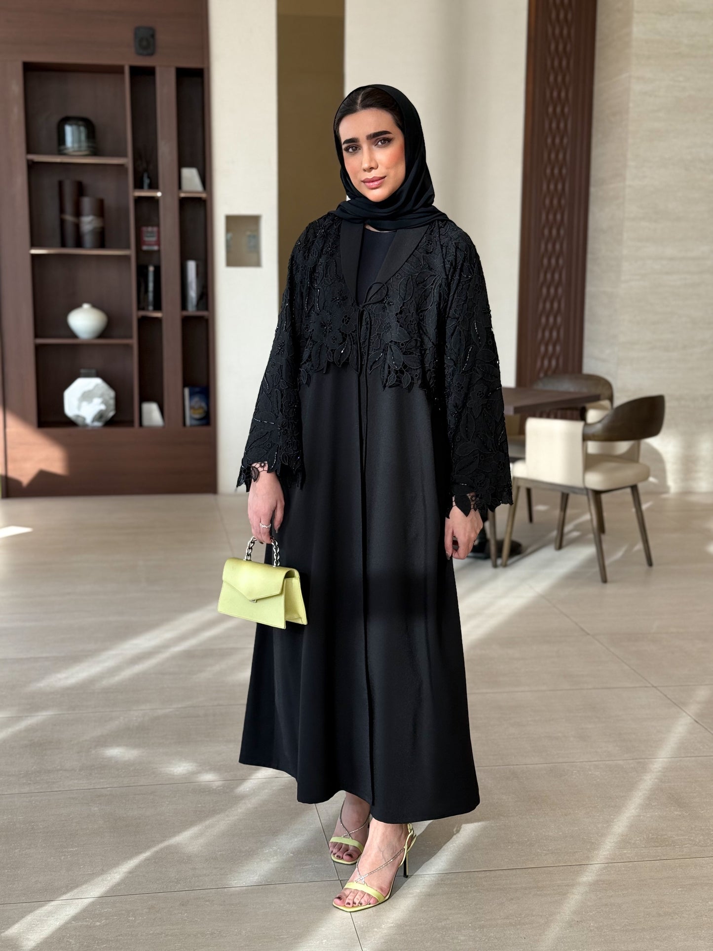 A black abaya with collar and unique embellishments