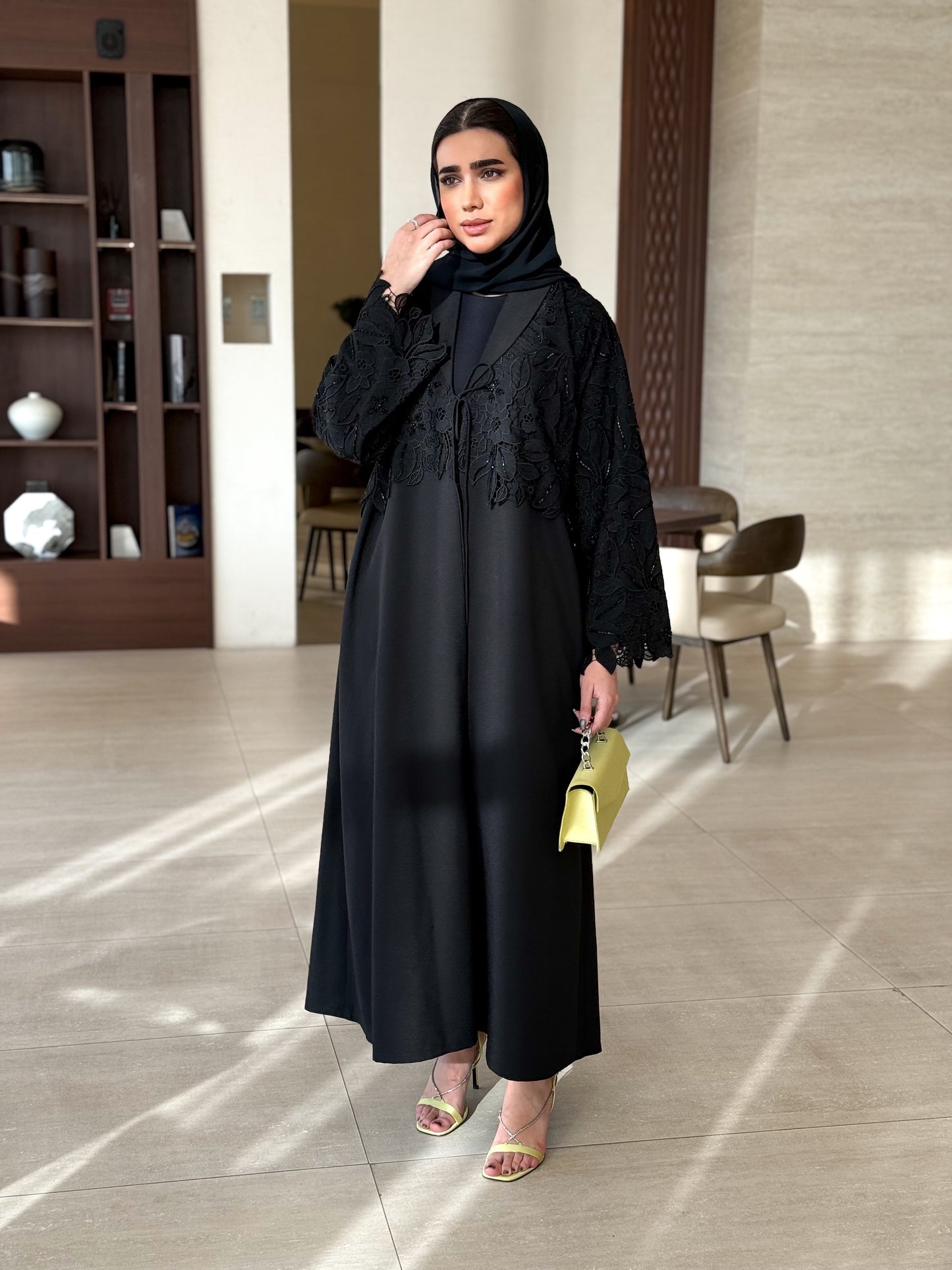 A black abaya with collar and unique embellishments